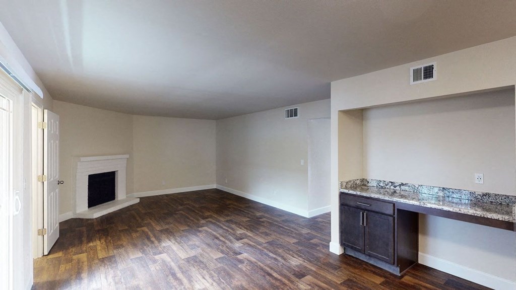 a living room with hardwood floors and a fireplace
