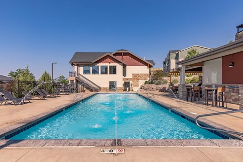 A large outdoor swimming pool with a building in the background.