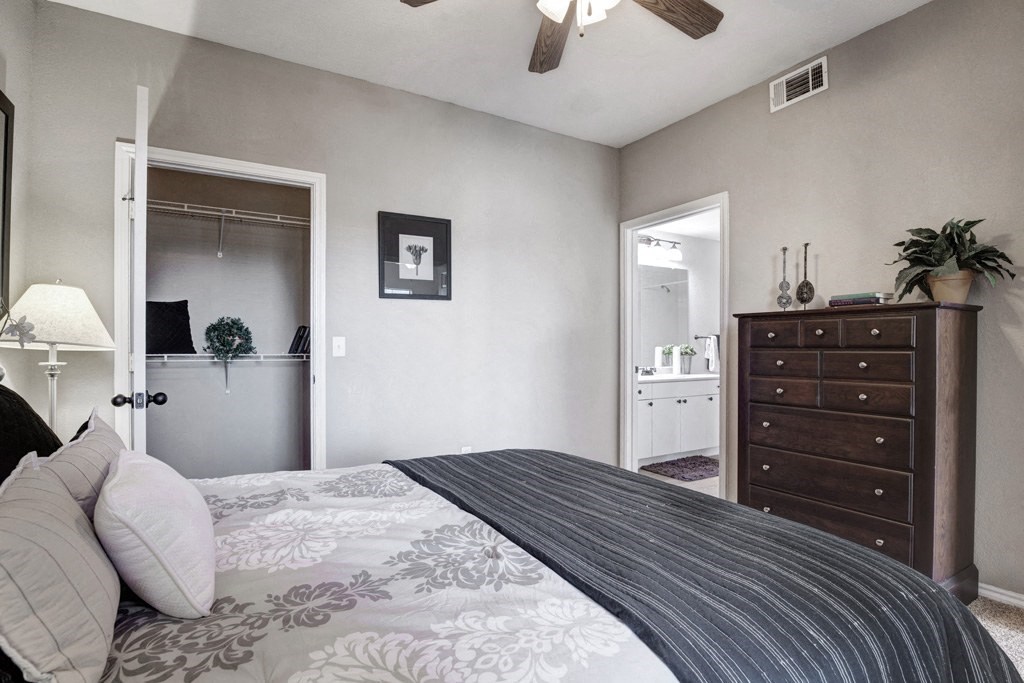 a bedroom with a large bed and a dresser