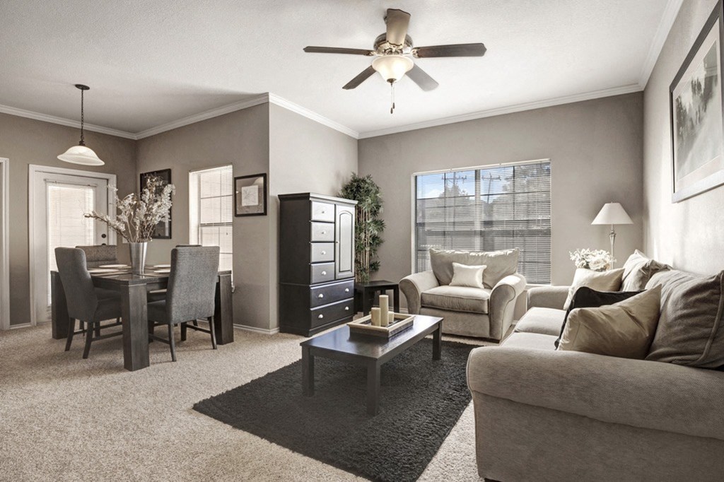 our apartments offer a living room with a couch a coffee table and a dining table