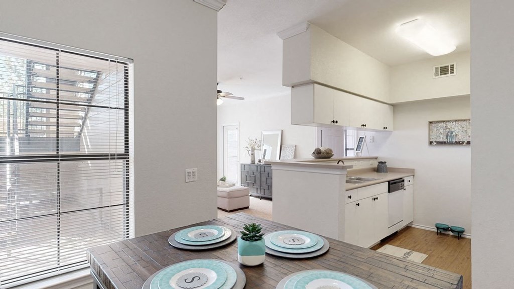 a kitchen and dining room with a table and chairs