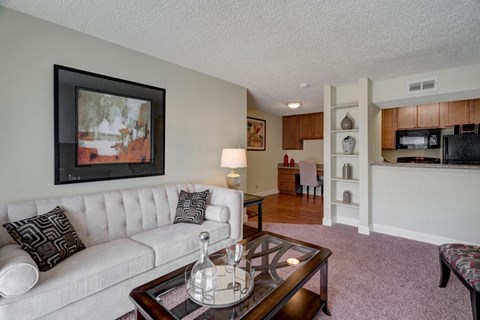 A living room with a white couch and a coffee table.