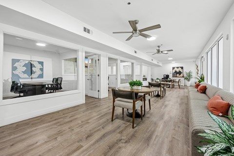 A modern living room with a dining table and chairs.