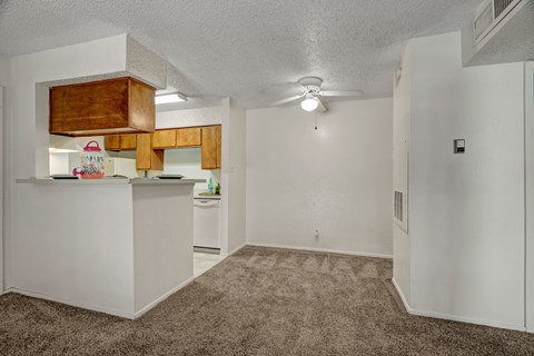 A kitchen with white cabinets and a brown rug on the floor.