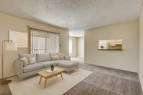A living room with a grey sofa and a wooden coffee table.