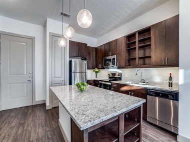 The Crosby at The Brickyard modern kitchen with granite countertops and wooden floors The Crosby at The Brickyard modern kitchen with granite countertops and wooden floors
