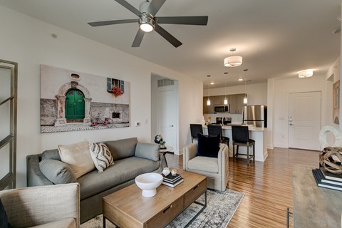 A living room with a grey couch and a coffee table.