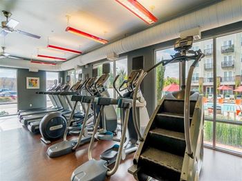 a room filled with cardio equipment and a large window