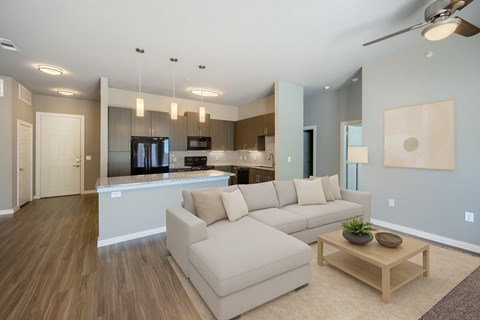 A modern living room with a large couch and a coffee table.