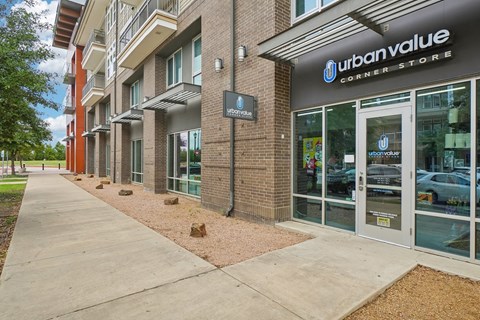 A storefront of Urban Value Corner Store with a sidewalk in front.