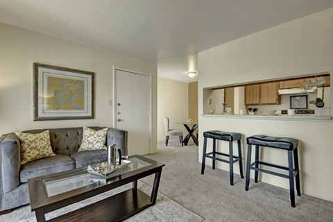 A living room with a grey couch and a coffee table.