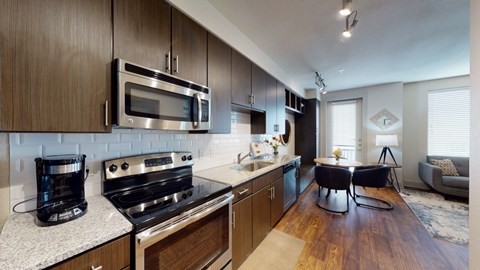 A modern kitchen with dark wood cabinets and stainless steel appliances.