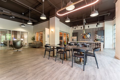 A modern dining room with a large table and chairs.