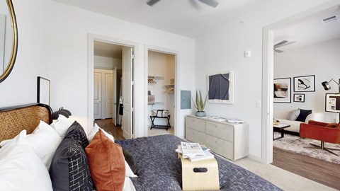 A bedroom with a bed, dresser, and mirror.