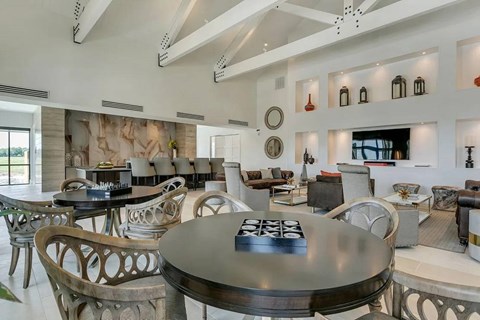 A modern dining room with a large table and chairs.