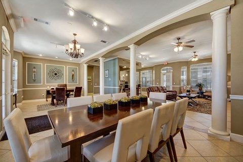A large dining room with a long table and chairs.