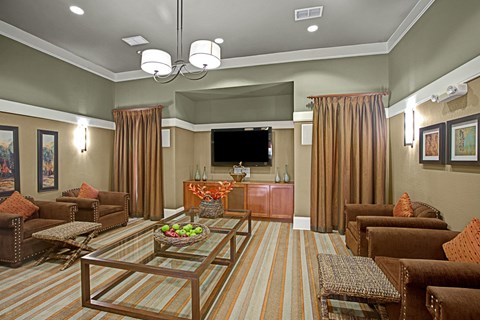 A living room with brown furniture and a flat screen TV.