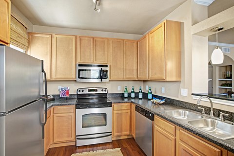 A kitchen with wooden cabinets and stainless steel appliances.