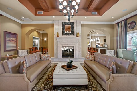 A living room with a fireplace and a chandelier.