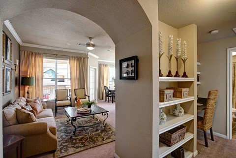 A living room with a couch, chairs, and a coffee table.