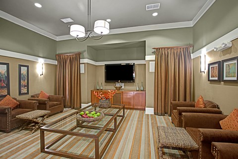 A living room with brown furniture and a flat screen TV.
