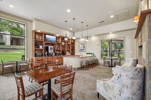 A modern dining room with a wooden table and chairs.