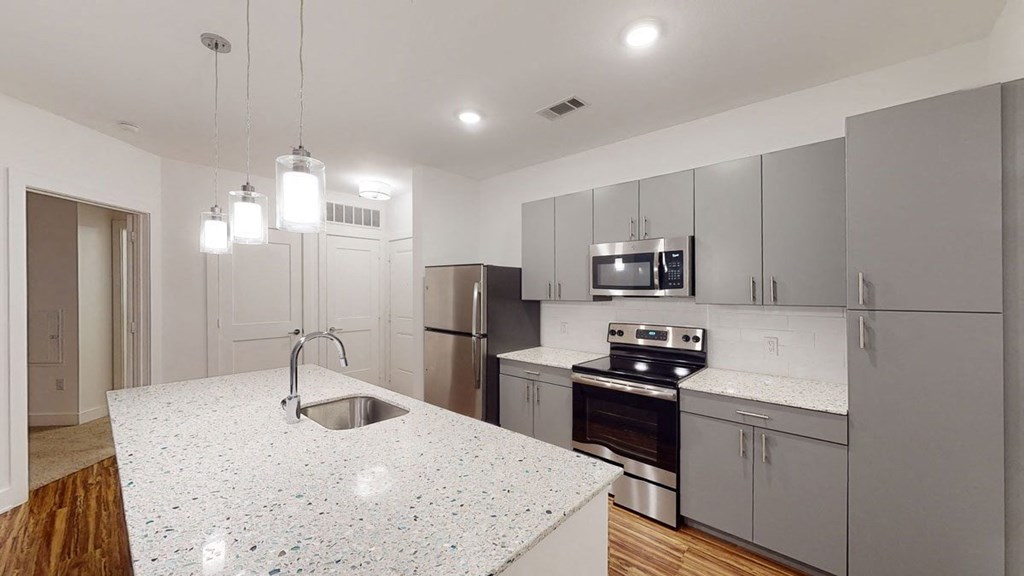 a kitchen with an island and stainless steel appliances