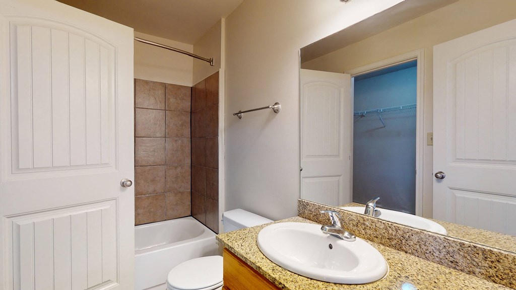 a bathroom with a sink and a tub and a mirror