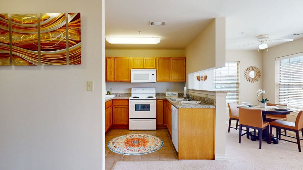 a kitchen and a dining room with a table