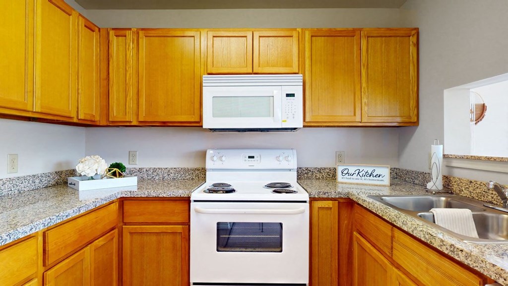 a kitchen with a stove microwave and sink