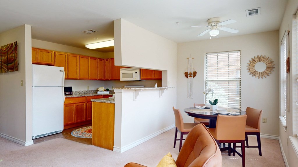 an open kitchen and dining room with a table and chairs