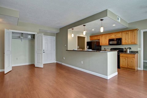 A kitchen with wooden cabinets and a white counter.