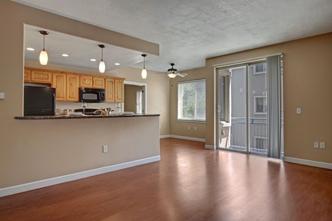 A kitchen with wooden cabinets and a countertop with a microwave and oven.