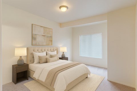 A bedroom with a large bed and two lamps.