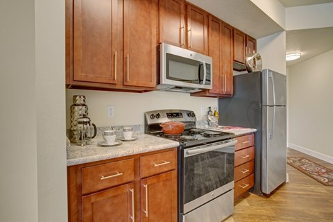 A kitchen with wooden cabinets and stainless steel appliances.