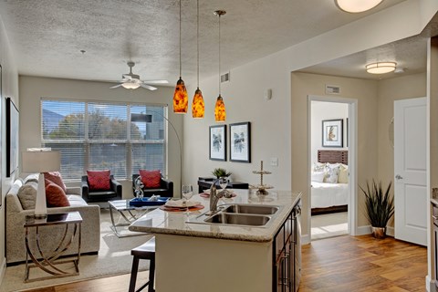 A kitchen with a white counter top and a sink.