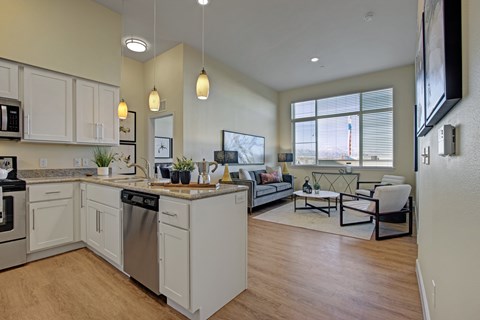 A modern kitchen with white cabinets and a large island.