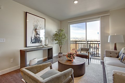 A living room with a brown floor and furniture.