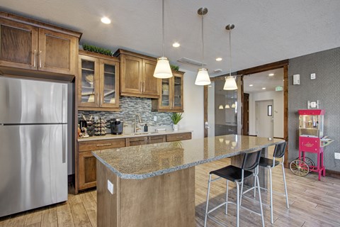 A kitchen with a granite countertop and a refrigerator.