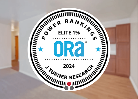 A badge with the text "POWER RANKINGS ELITE 1%" and "ORA 2024" is superimposed on an image of a room.