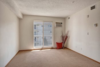 A living room with sliding glass doors Villagio Apartment Homes Living Room - Photo Gallery 4