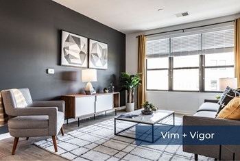 Vim + Vigor living room with modern accent wall and windows Vim + Vigor Lofts living room with natural light and modern structure - Photo Gallery 3