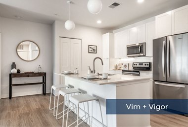 Vim + Vigor Lofts kitchen with stainless steel appliances and hardwood floors