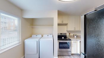 a kitchen with a washer and dryer