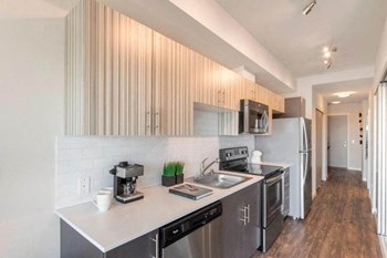 Galley style kitchen with stainless steel appliances and overhead lighting Vive kitchen - Photo Gallery 3