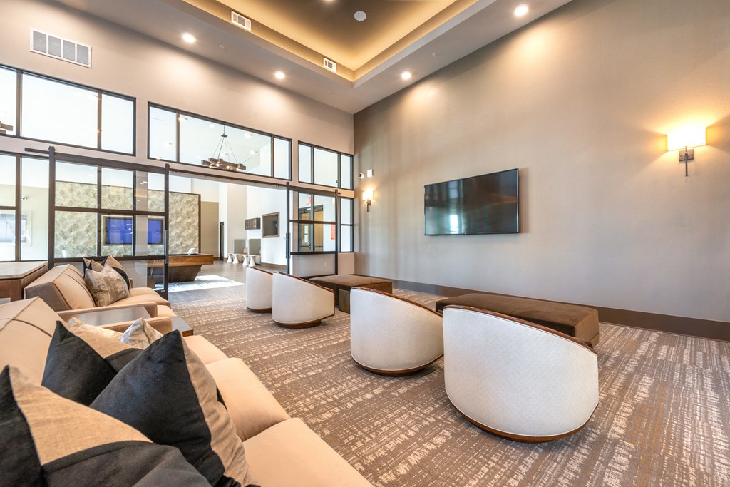 a living room with couches and chairs and a television