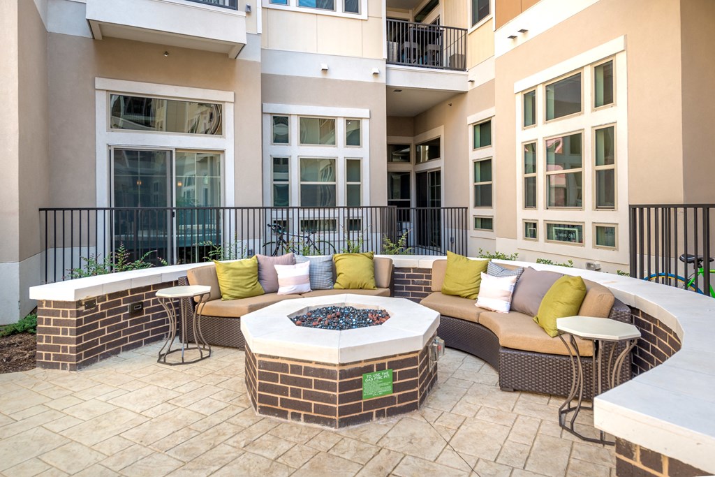 an outdoor patio with furniture and a fire pit