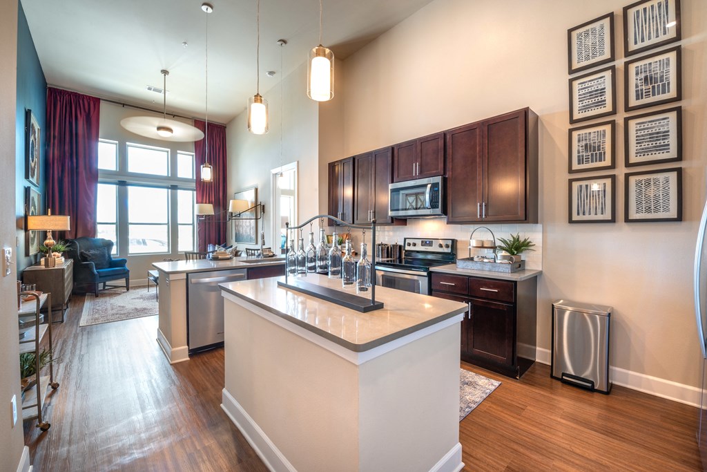 a kitchen with a large island and a living room
