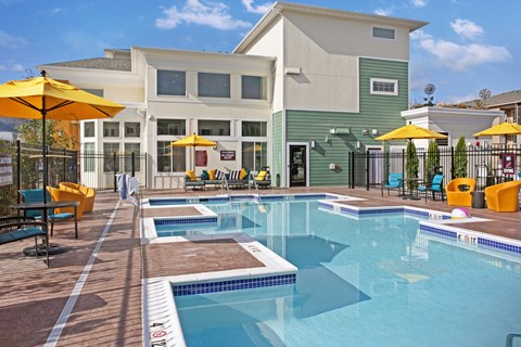 A large swimming pool with a building in the background.
