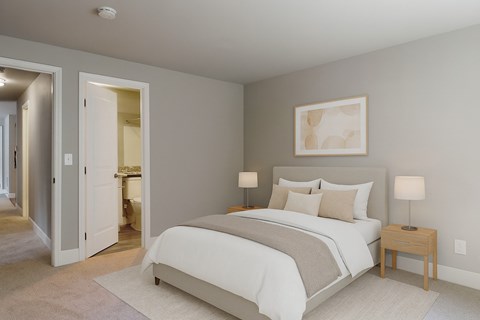 A bedroom with a large bed and a painting on the wall.